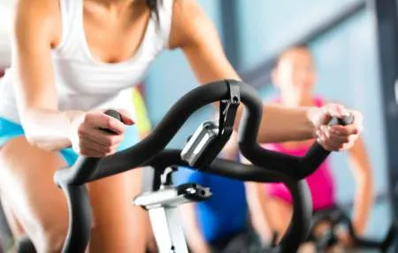 Exercise bike workout representing getting back in shape after the holidays with naturopathic fitness tips