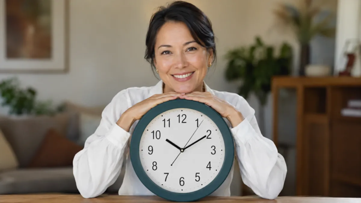 Smiling woman holding a wall clock, representing the timing hypothesis of hormone therapy for perimenopause