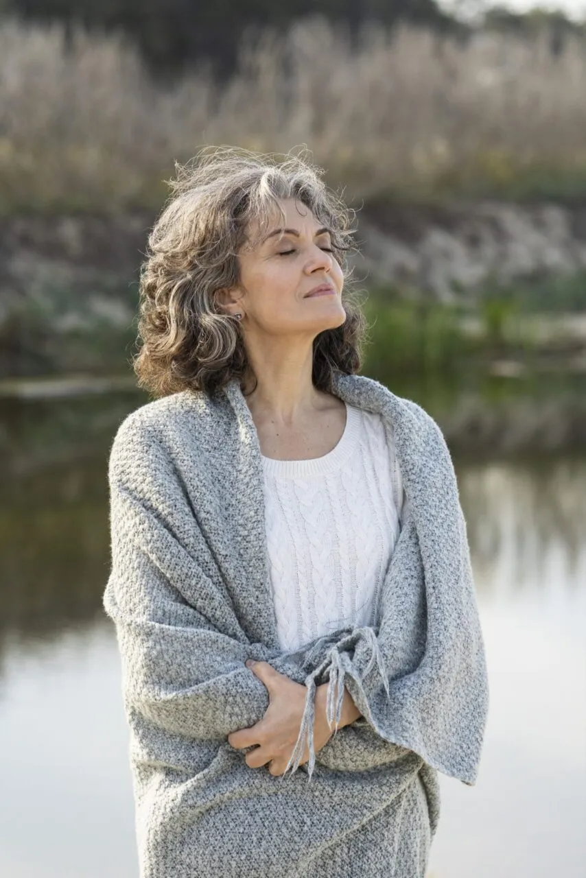 Woman by a lake representing low testosterone symptoms and peptide therapy options for women