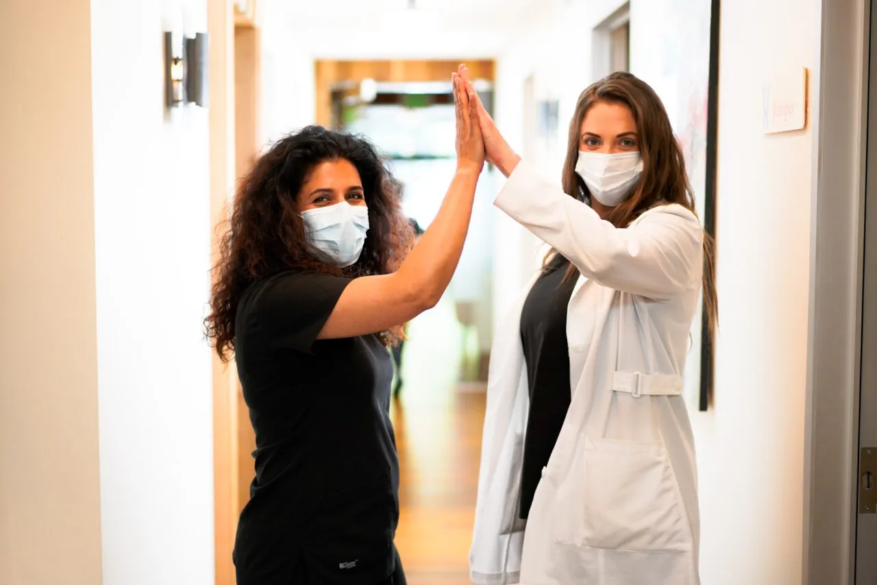 Dr. Darvish and colleague celebrating holistic pain therapy success at Holistique naturopathic clinic