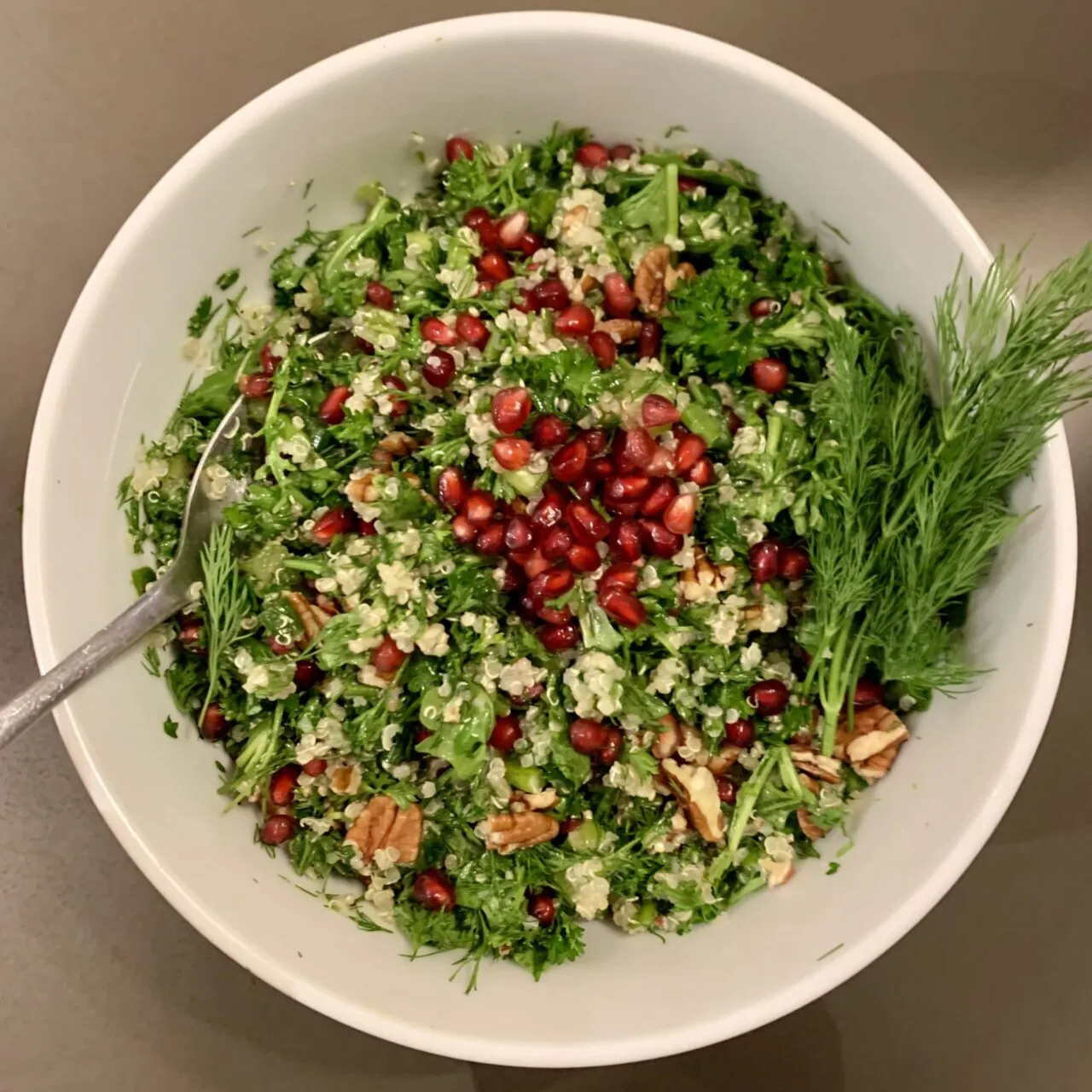 Colorful pomegranate quinoa arugula salad bowl with nutrient-dense superfoods